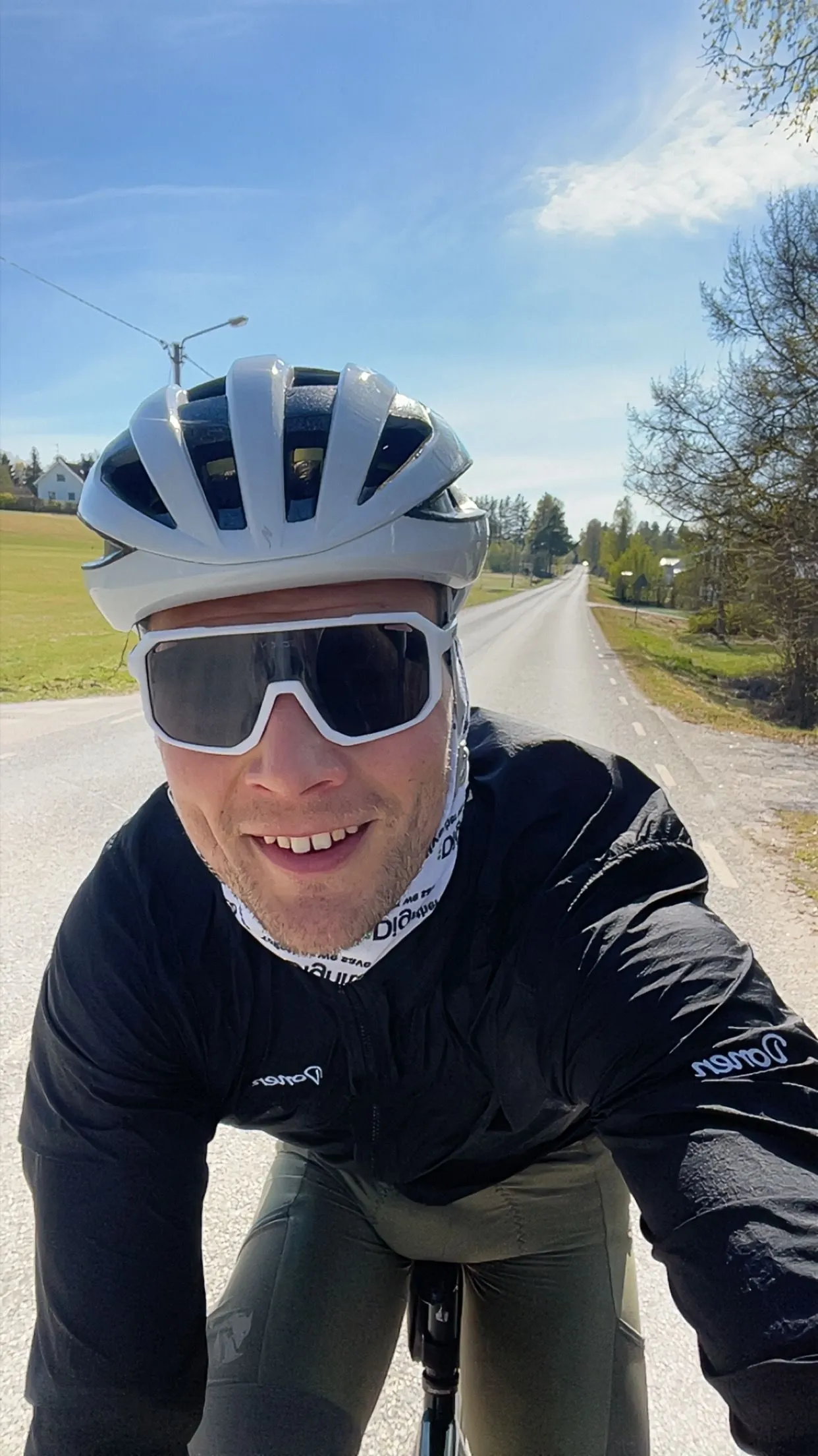 Alfred on a sunny training ride on a quiet Swedish country road, white helmet and sunglasses